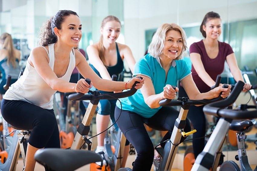 Older woman working out in gym with other woman. Just like making yourself better it's important to look at what's better - Zirconia or Titanium Implants?