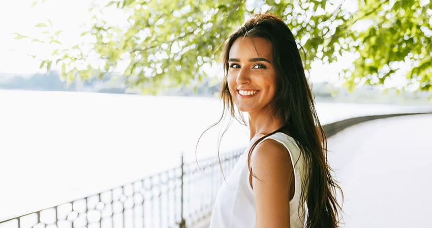 Woman Smiling Outdoors Wearing Invisalign